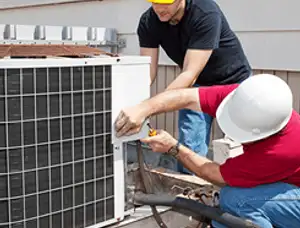 HVAC technicians repairing an outdoor AC unit on a rooftop in Saint Charles, MO
