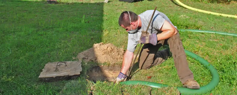 Septic pumping technician servicing a residential septic tank in Saint Charles, MO