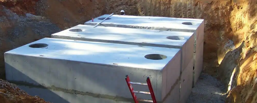 Septic tank installation site with a newly placed concrete tank in Saint Charles, MO